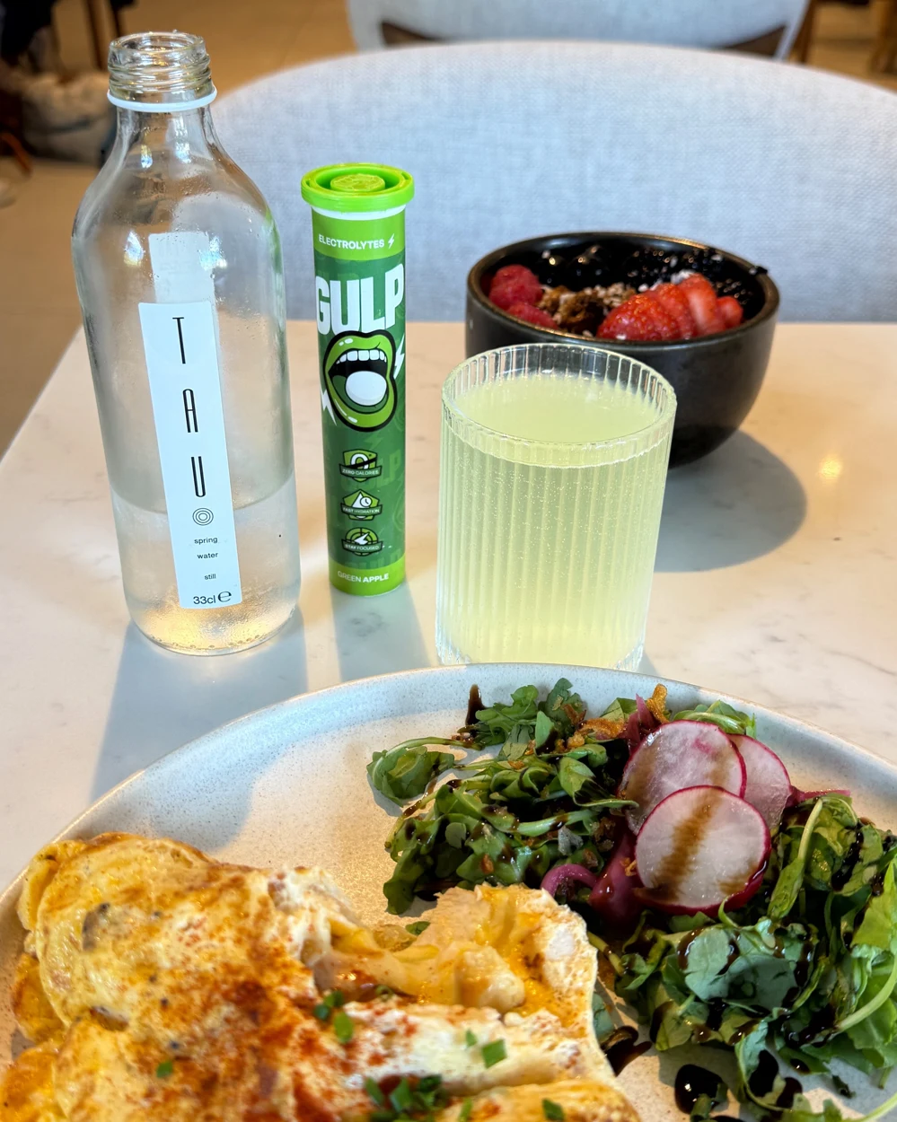 Green Apple GULP with a glass of water and breakfast