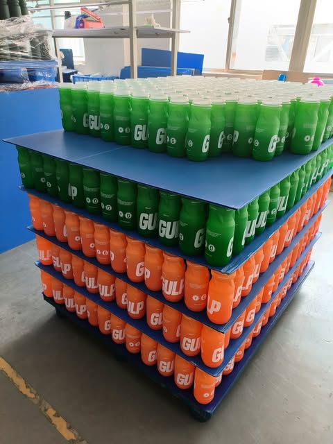 Rows of green and orange GULP bottles ready to go