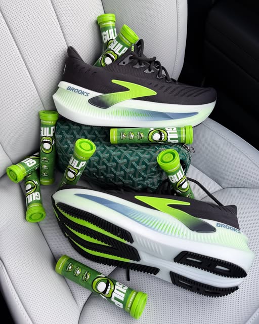Green Apple GULP tubes alongside running shoes and a bag